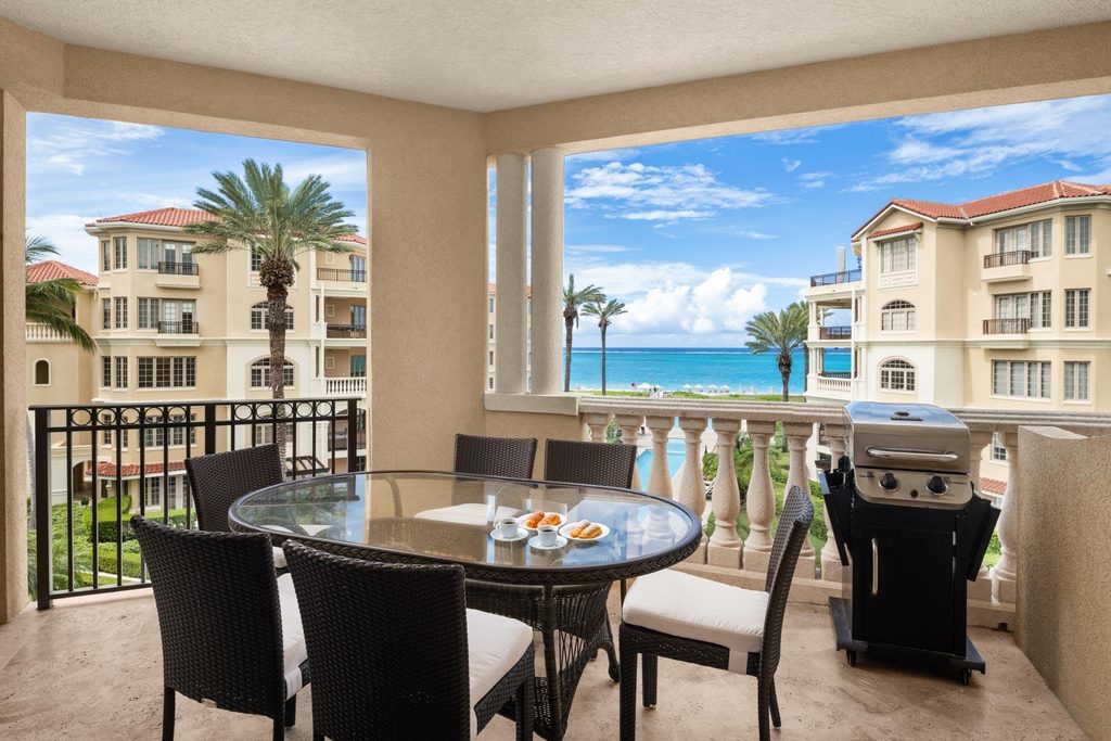 The Somerset Unit 303 balcony with dining table, grill and ocean view, Grace Bay, Turks and Caicos